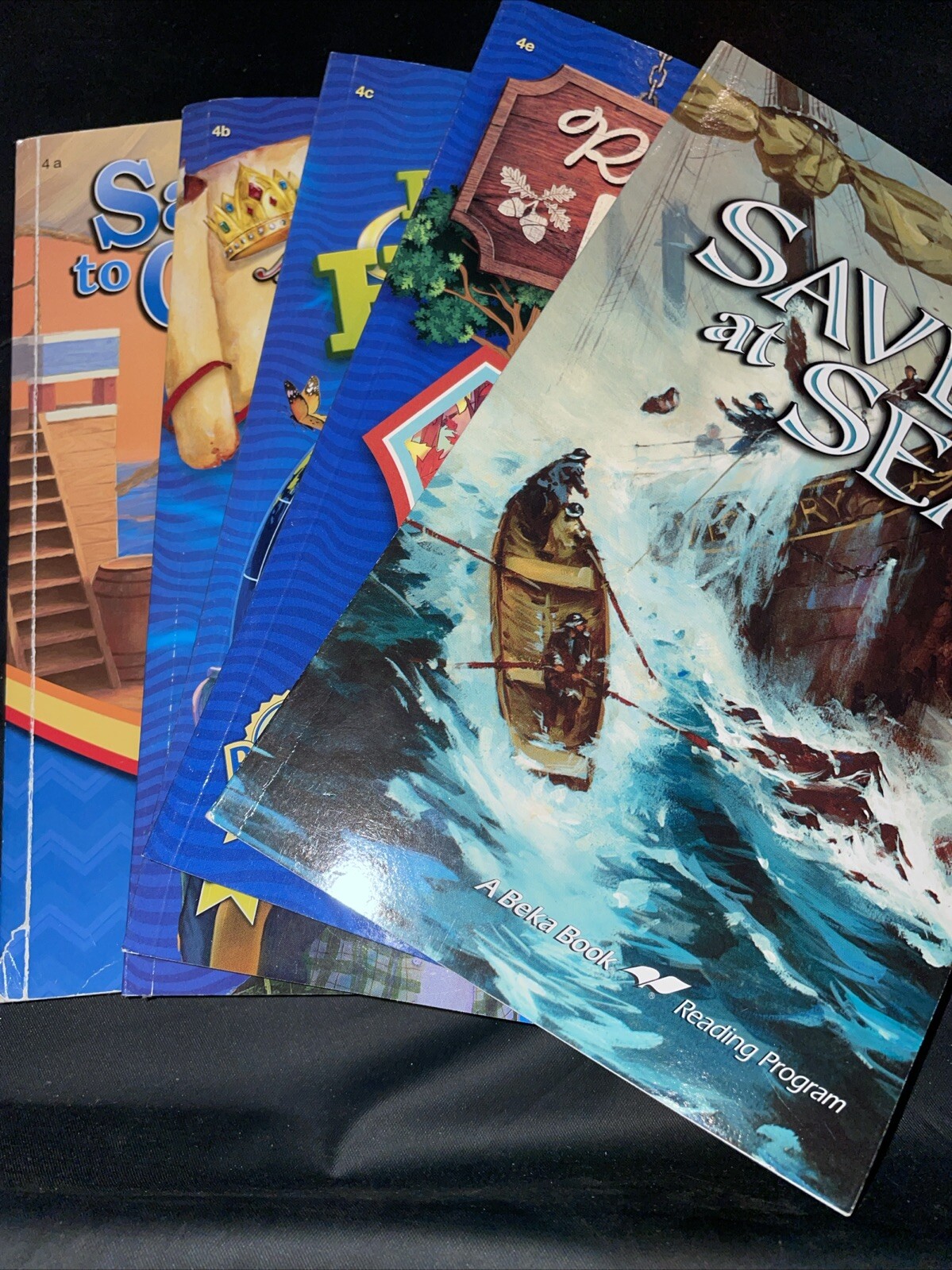 A beka 4th grade readers: 4a, 4b, 4c, 4e, plus Saved at Sea.